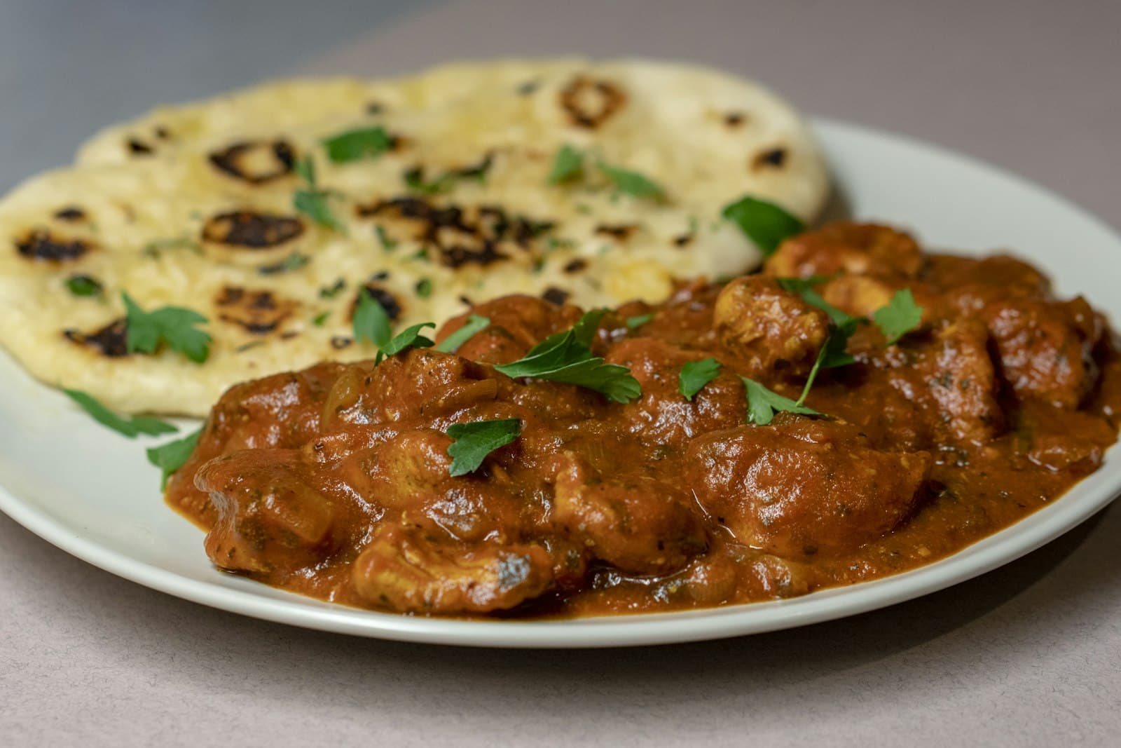 Butter chicken curry served with naan bread
